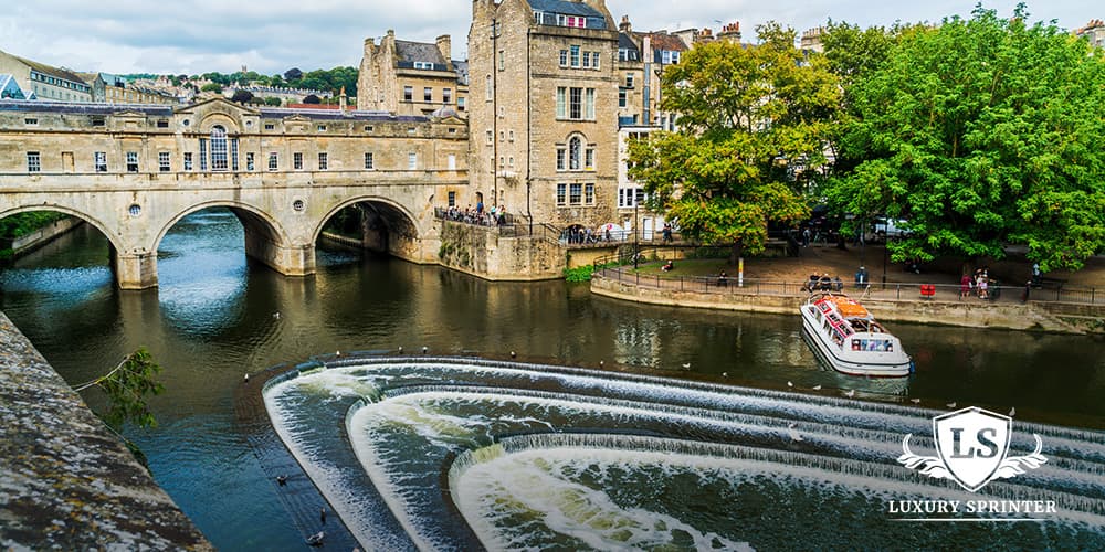 View of the historic Pulteney Bridge crossing the River Avon in Bath, England, with classic Georgian buildings.