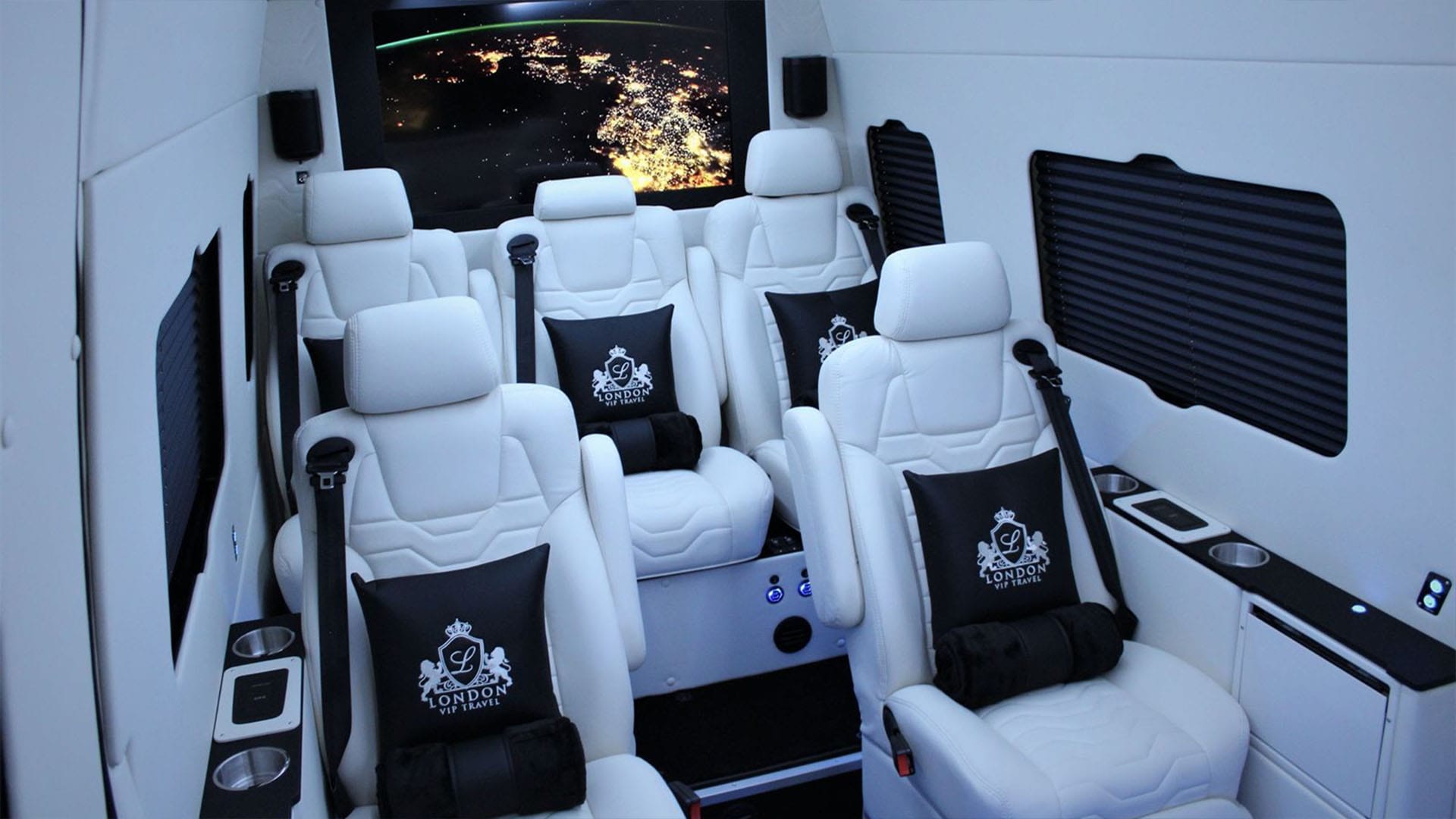 Interior of Mercedes 7-seater Luxury Sprinter featuring plush seating, ambient lighting, and spacious premium layout.